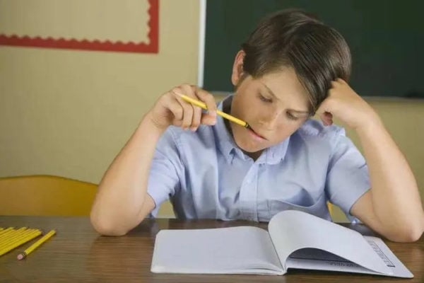 A Boy Biting A Pencil-Is Pencil Lead Toxic?